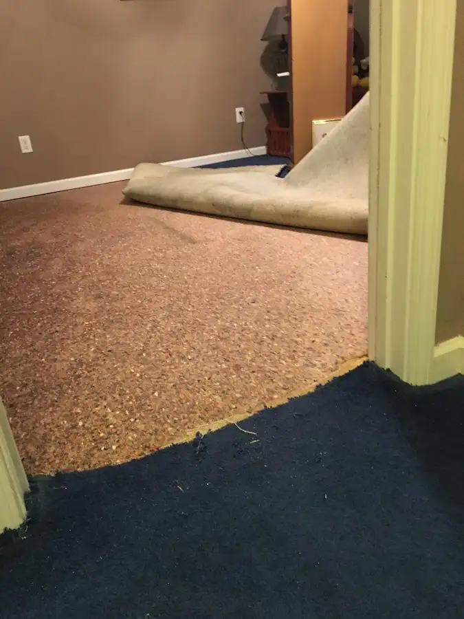 Carpet pad removal revealing water damage during Water Mitigation Services in Crest Hill